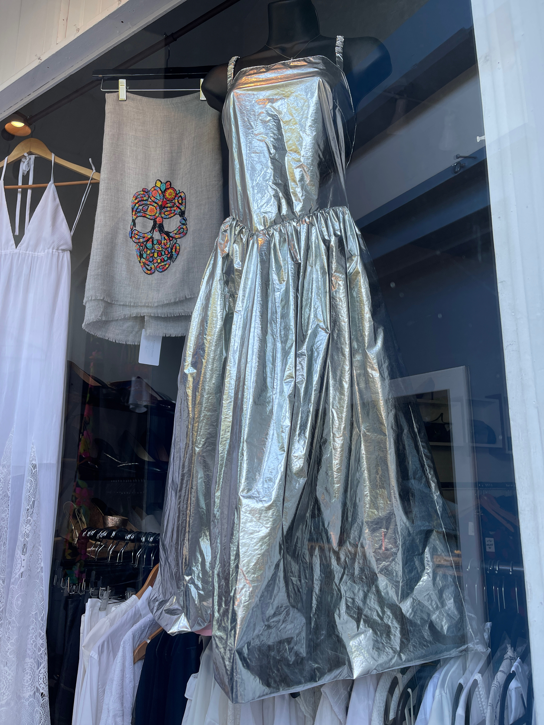 Silver formal dress in a shop window.