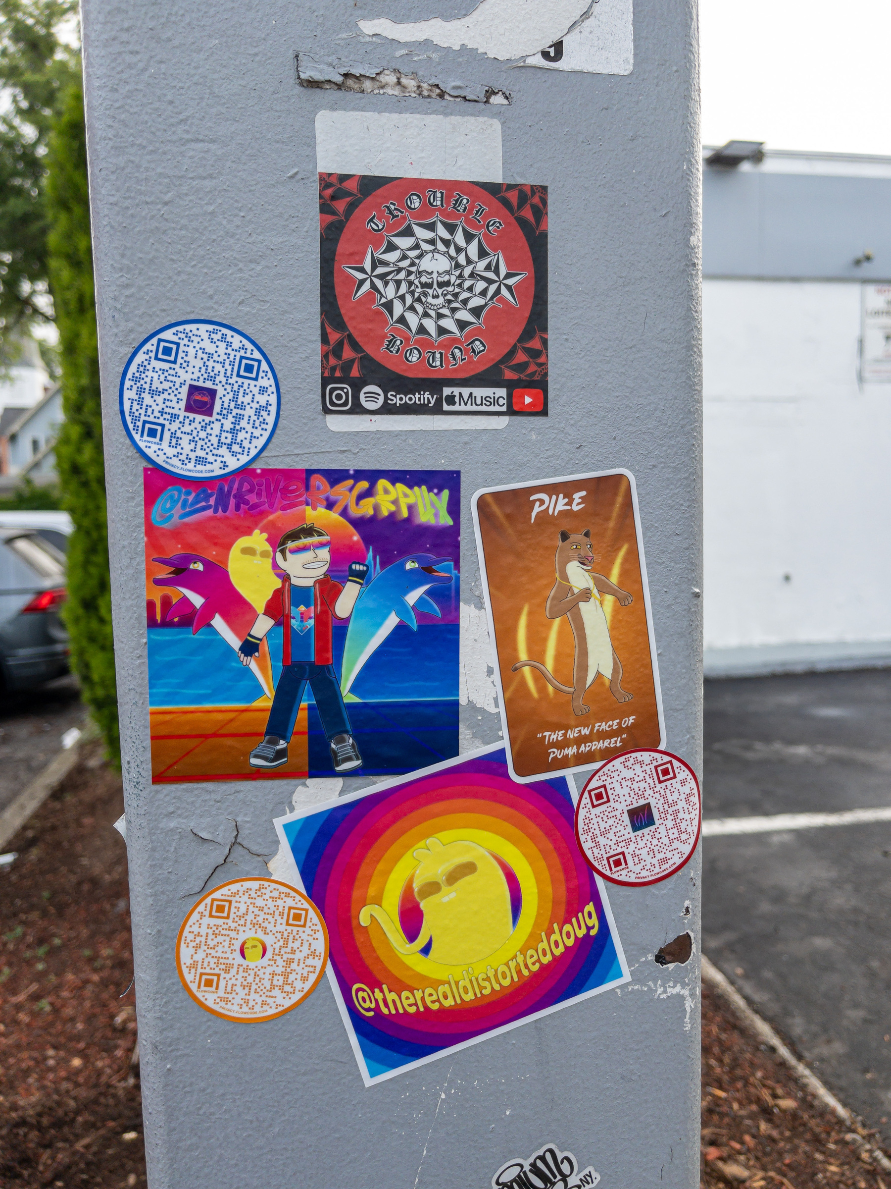 Colorful stickers on a utility pole.