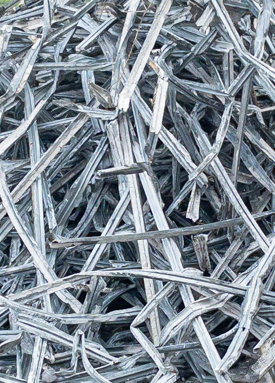 Close up of a spaghetti tangle of metal channels at a demolition site.