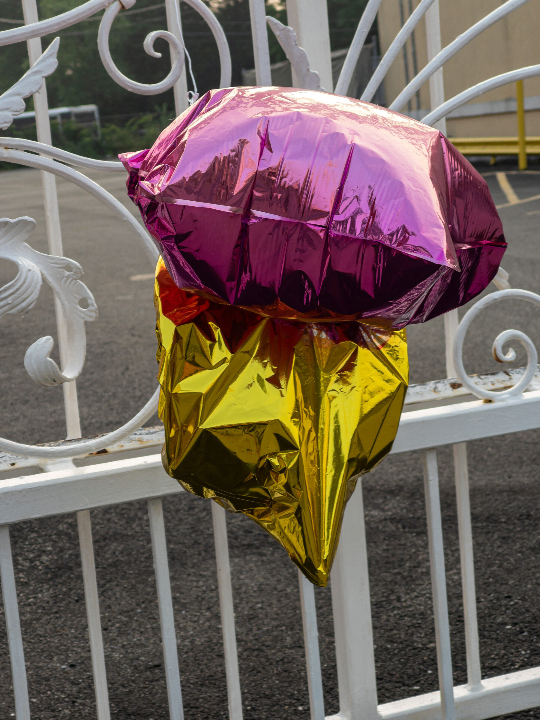 Deflated purple and yellow star shaped metallic balloons.