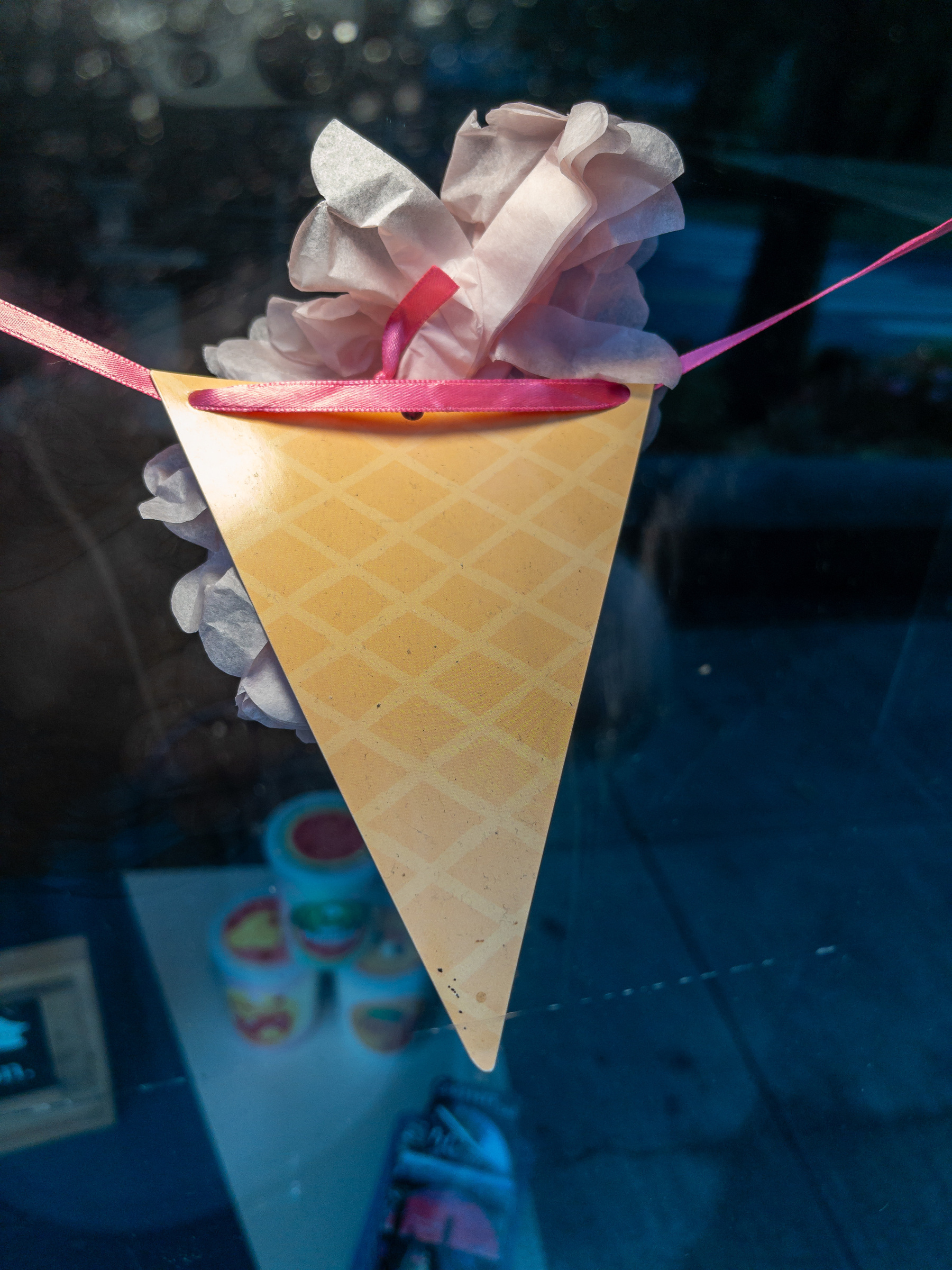 Paper ice cream cone in a shop window.