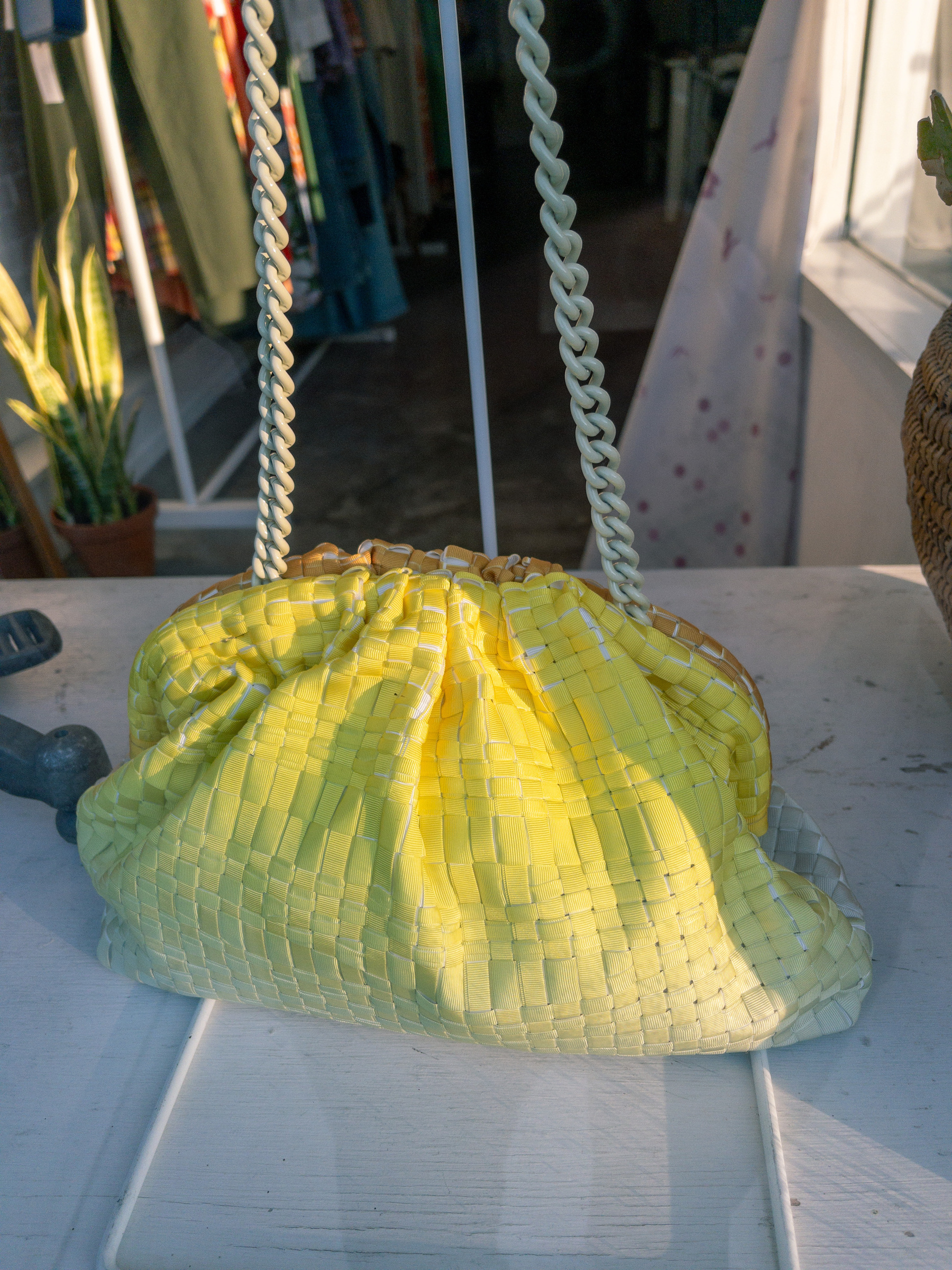 yellow woven. fabric purse in shop window